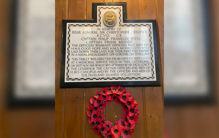 A poppy wreath hangs from the memorial tablet of those lost on November first 1914 from HMS Good Hope and HMS Monmouth.