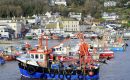 Fishing boats at the entrance to the harbour at Lyme Regis Dorset England