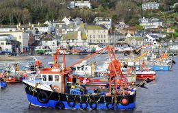 Fishing boats at the entrance to the harbour at Lyme Regis Dorset England