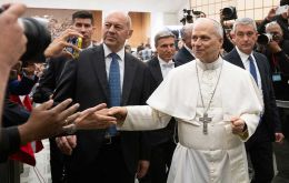 Pope Leo XIV walks down to greet journalists at a meeting in the Paul VI audience hall ten days ago 2025.