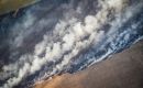 A wildfire during 2023's drought is fought by a crop duster plane in Rocha eastern Uruguay. Photo: Sebastian Astorga Rostani