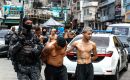 Members of the Rio de Janeiro Police transfer a group of people during an operation on Tuesday. Antonio Lacerda/EFE/EFE
