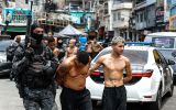 Members of the Rio de Janeiro Police transfer a group of people during an operation on Tuesday. Antonio Lacerda/EFE/EFE