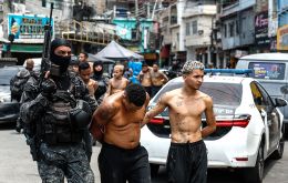 Members of the Rio de Janeiro Police transfer a group of people during an operation on Tuesday. Antonio Lacerda/EFE/EFE