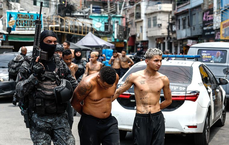 Members of the Rio de Janeiro Police transfer a group of people during an operation on Tuesday. Antonio Lacerda/EFE/EFE