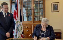 Gov. Colin Martin-Reynolds and Returning Officer Dr Andrea Clausen sign papers to dissolve the Legislative Assembly and confirm December 11 as the date for the General Election 