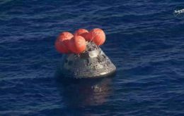 Teams from NASA, the U.S. Navy and Air Force, deployed from the USS John P. Murtha, proceeded with crew recovery