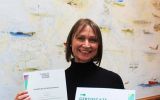 Clare proudly showing her diplomas 