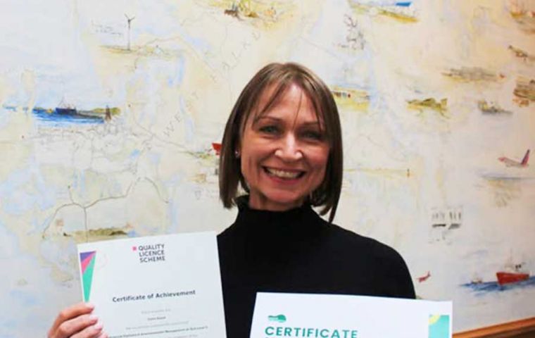 Clare proudly showing her diplomas 