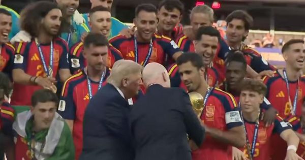 Trump takes center stage at the World Cup final, presenting Spain's trophy and holding it beforehand