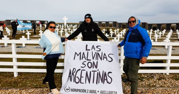 Replica of the flag shown by Argentina's football team unfurled at Darwin cemetery