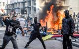 From early afternoon, groups built barricades from burning rental bicycles in the streets around the square and looted some shops, while police responded with tear gas