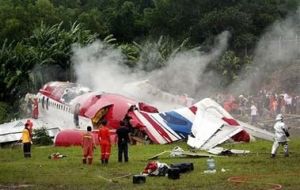 The One-Two-Go plane on the side of the runway after it crashed