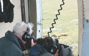 Ian and Georgina Strange taking aerial survey photographs from the door of a helicopter (Photo Ãâ€šÃ‚Â© Dan Birch)