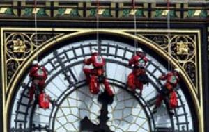 Glaziers abseil down the clock face