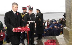 Minister for Veterans Derek Twigg MP lays a wreath at the Cross of Sacrifice in Stanley<br>[Photo: HQ BF SAI]