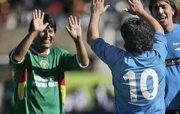 Pte. Evo Morales is congratulated by Diego Maradona during a show match