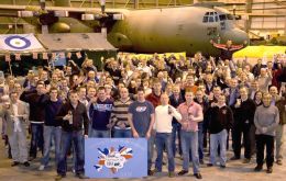 Tucked under the wing of a C-130 aircraft, 1312 Flight celebrate 25 years in the Falklands