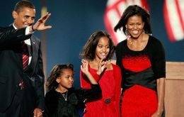 Less than an hour after sealing his hold on the White House, Obama and his wife, Michelle, stepped onto the stage holding the hands of their two daughters