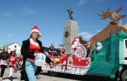 May Queen, Robyn Berntsen and Princess, Verity Livermore, are drawn past the    Liberation Monument on Santas sleigh