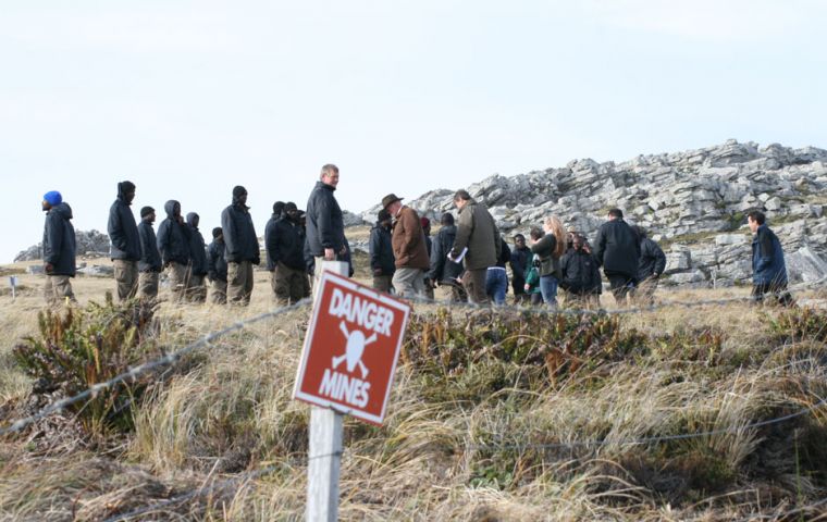 De-miners and officials pictured in the middle of what was Minefield 25