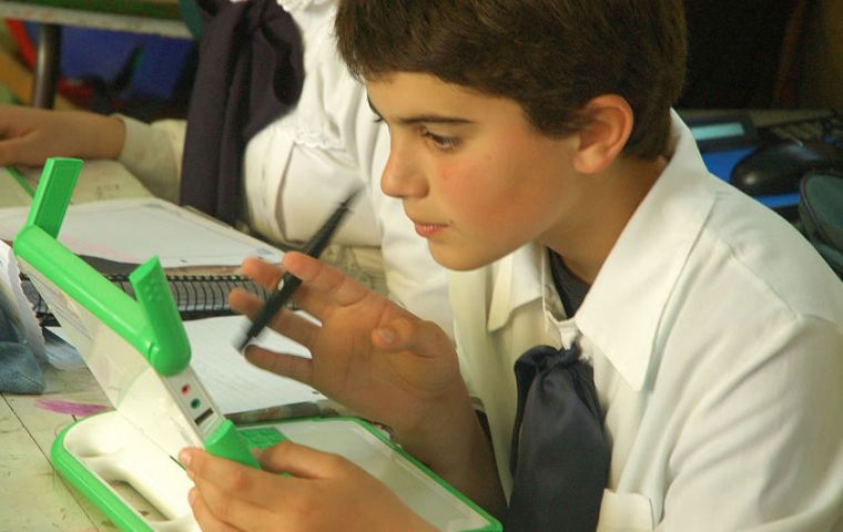 A common sight in open spaces: school children with their green laptops 