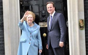 The Iron Lady and Cameron wave at photographers