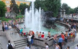 Young girls cool off in a fountain. Moscow has recorded 38 degrees Celsius  