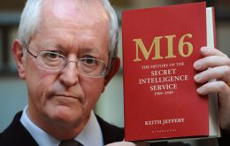 Professor Keith Jeffery poses for photographers with his book “MI6 The History of the Secret Intelligence Service 1909-1949