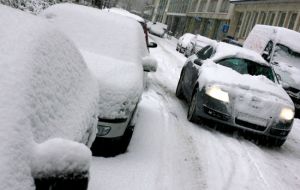 A blanket of snow covers homes, vehicles and roads 