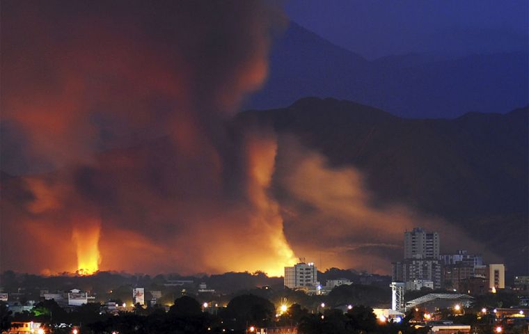 Flames engulf the military depot at Maracay following a series of explosions. (Photo AFP)