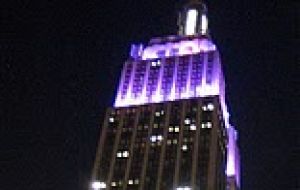 Iconic Empire State Building lit in white, blue and purple