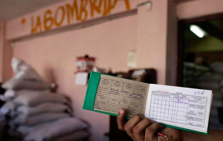 Cubans receive monthly allocations of rice with their ration cards 