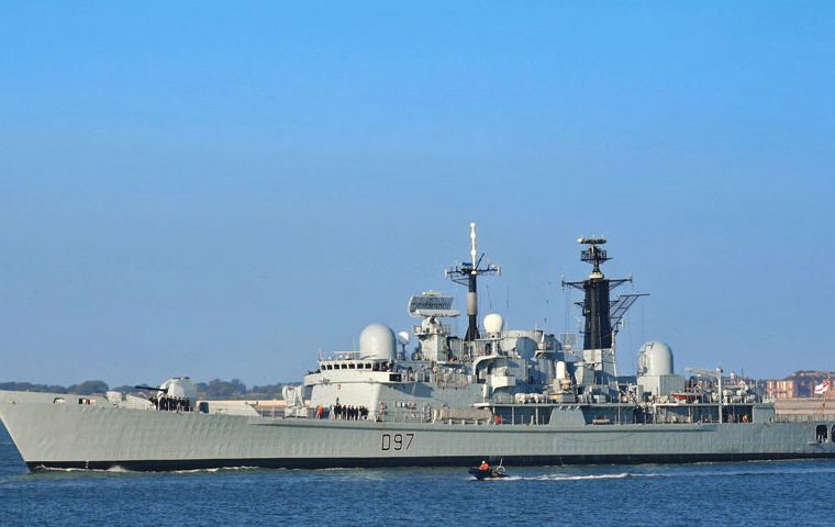 With a flash of fire from her saluting gun, the Fortress of the Sea makes her ceremonial entry into the home of the South African Navy