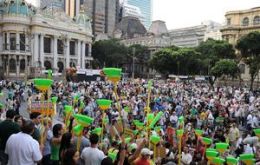 Demonstrators march along the streets of Rio with brooms and placards 