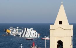 Costa Concordia is on her side with a 90 meters long gash in the hull (Photo AP)