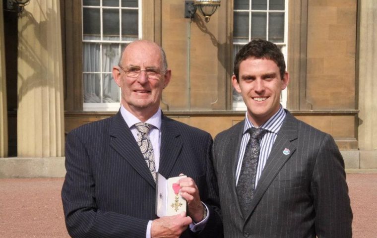 A proud Richard OBE next to his son Sam outside Buckingham Palace 