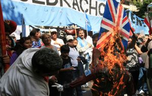 Protestors burn a Union Jack during the clashes next to the British Embassy