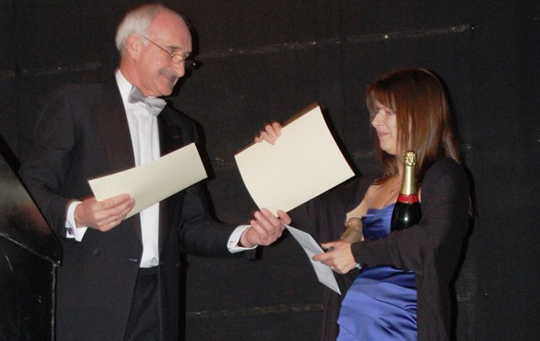 Sarah Clement accepts from Mike Summers MLA an award on behalf of her sister Debs Summers for Best Falkland Ambassador at the Tourism awards on Saturday night - Picture L Watson