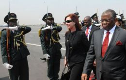 President Cristina Fernandez is met at the airport by Angolan officials 