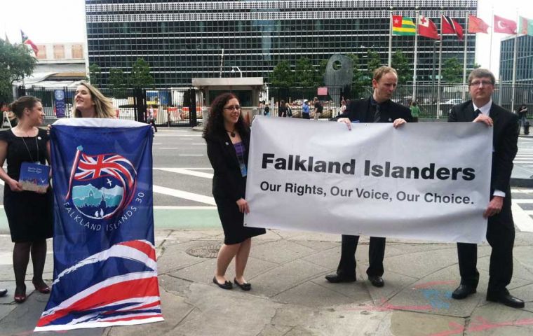 Young Falkland Islanders with a banner displayed before the UN building in New York (Photo: BBC) 