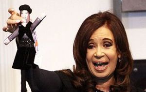 The Argentine president with her presidential doll in black 