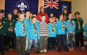 Scouts and beavers line up with Rebecca and the torch