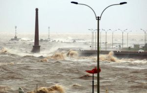 Huge waves cover Montevideo’s rapid transit way next to the River Plate 