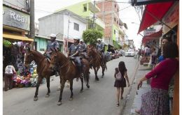 Mounted police patrol the streets of some of the poor areas of the city