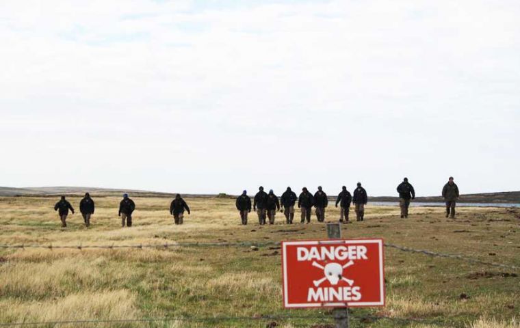 The Zimbabwe team celebrates previous successful clearances of areas that included Surf Bay, Goose Green, Sapper Hill and part of Stanley Common