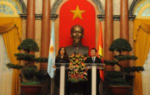 Cristina Fernandez and Truong Tan Sang with Ho Chi Minh overlooking   