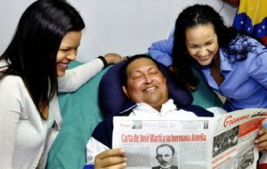  Hugo Chavez and his daughters, as he holds a copy of Cuba's state newspaper Granma in Havana, Cuba, Thursday, Feb. 14.2013