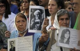 Members of the Human Rights organization Madres de Plaza de Mayo Linea Fundadora and other demonstrators hold portraits of people who went missing in the 1976-1983 military dictatorship (AFP)
