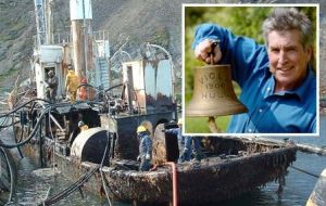 Dr Robb Robinson of the Maritime Historical Studies Centre in Hull, with the bell from the Viola, which is rusting in South Georgia